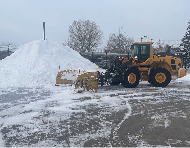 Loader beside a stacked snow pile
