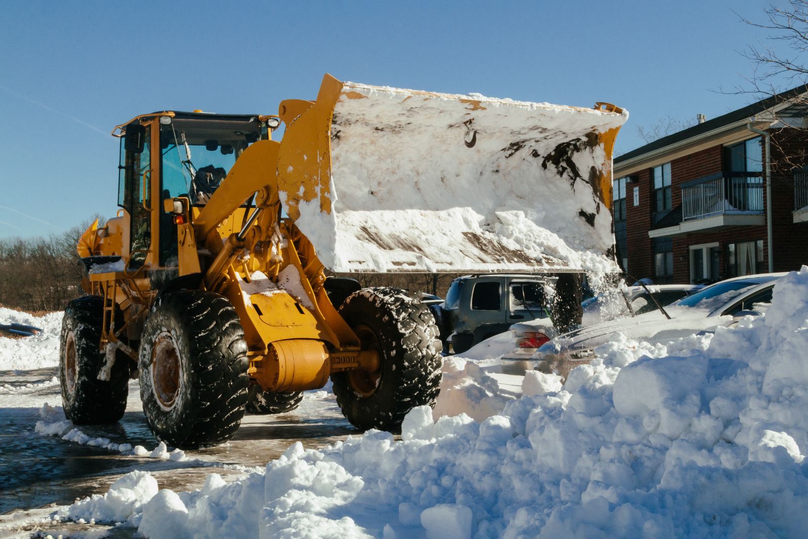 Adept loader with pusher blade on a cleared commercial lot